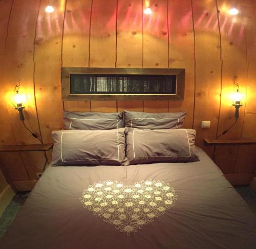 a bed with a heart on it with two lights at Le Grenier à Luge in Les Gets