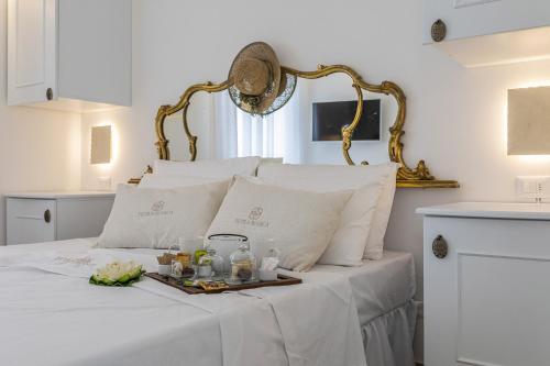 a white bed with a tray of food on it at Petra Bianca in Torre San Giovanni Ugento