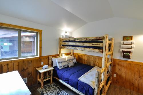 a bedroom with a wooden bunk bed and a window at Glacier Homestead in Coram