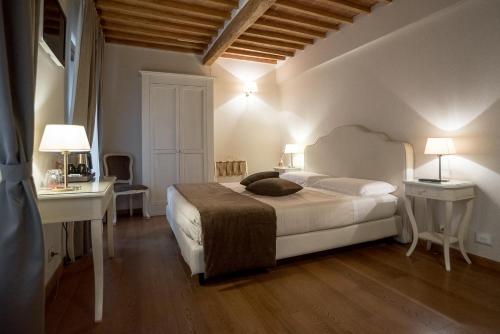 En eller flere senger på et rom på Le Camere Del Ceccottino