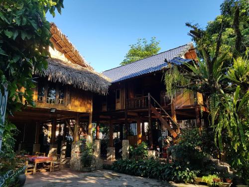 een huis met een rieten dak bij Mai Chau Home in Mai Chau