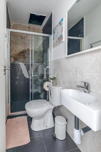 a bathroom with a toilet and a sink and a shower at AYZ Juan de Mena - Auto check-in property in Madrid