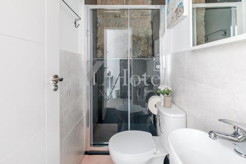 a bathroom with a shower and a toilet and a sink at AYZ Juan de Mena - Auto check-in property in Madrid