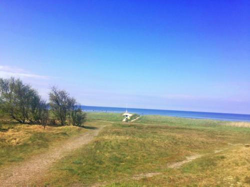 a dirt road in a field near the ocean at Villa Lindell in Höganäs