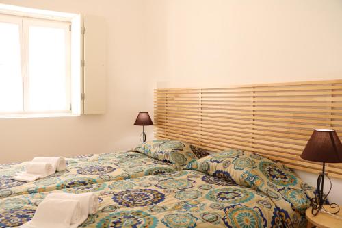 a bedroom with two beds and a window at Kalathos Houses in Lisbon