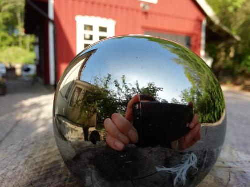 a reflection of a person holding a camera in a mirror at Ynde Private Apartment in Sölvesborg