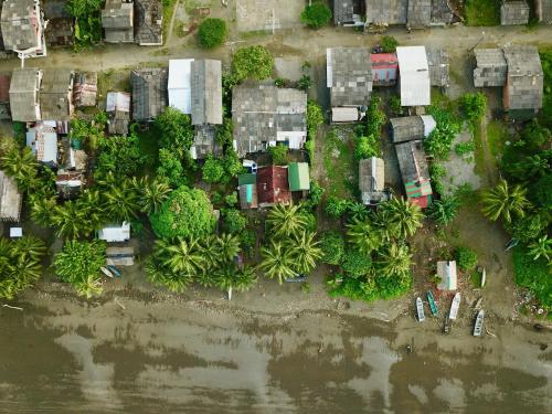 an aerial view of a group of houses next to a river at Casa Colibrí in Nuquí