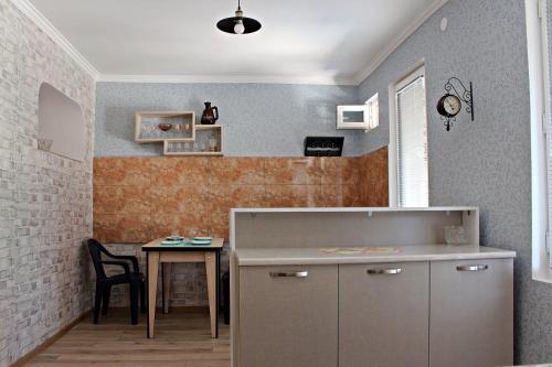 a kitchen with a table and a dining room at Kacharava apartments in Tbilisi City