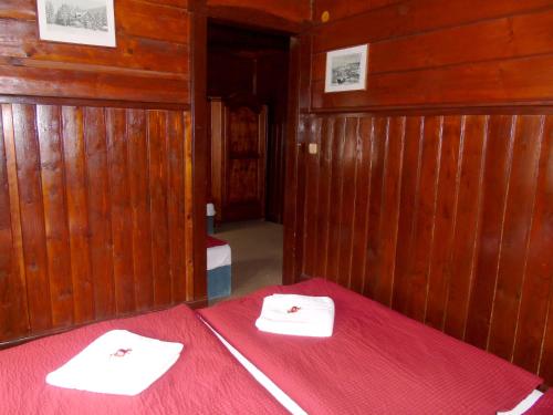 a room with a bed with a red blanket at Hotel Diana in Špindlerův Mlýn