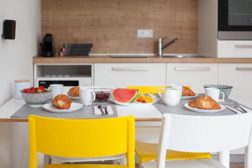 a kitchen with a table with plates of food on it at Apartments Coast 27 in Podgora