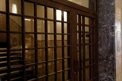 a wooden door with glass panels in a room at Relais Pensiero in Verona