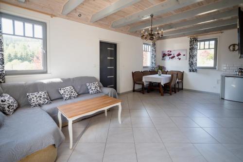 a living room with a couch and a table at Domek Skowronek in Szczytna
