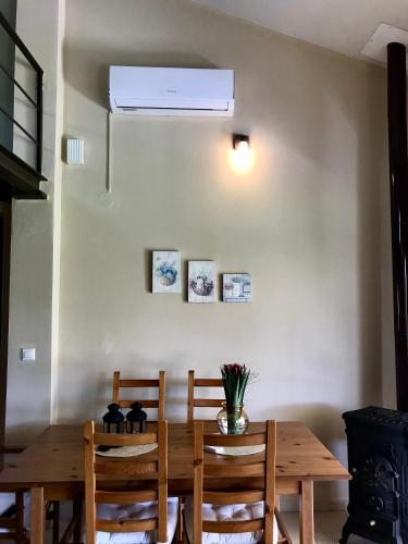 a dining room with a wooden table and chairs at Plane Tree House in Mákri