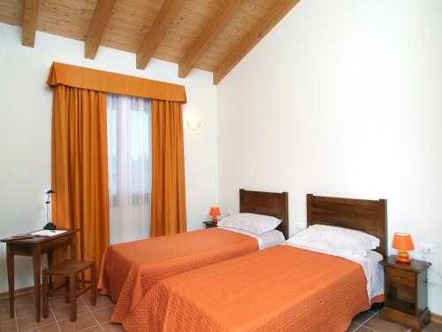 Postel nebo postele na pokoji v ubytování Agriturismo Ai Laghi
