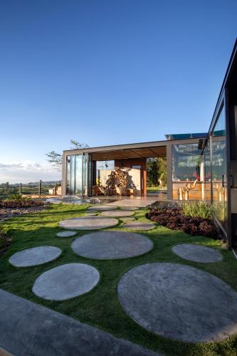 a garden with stepping stones in front of a house at Bio Habitat Hotel in Armenia