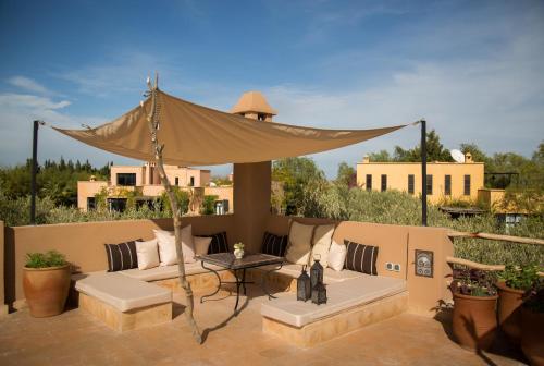 a patio with a couch and a canopy at Fawakay Villas in Sfiani