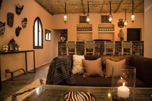 a living room with a couch and a table at Fawakay Villas in Sfiani