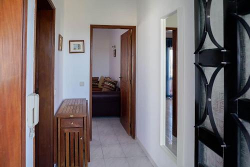 a hallway leading to a living room with a couch at Studio Apartment with Sea View & Fibre Internet in Albufeira