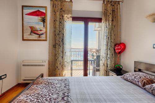 a bedroom with a bed with a view of the ocean at Beki Apartment in Bar