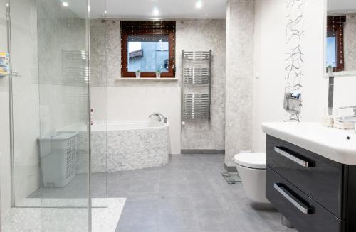 uma casa de banho com um chuveiro, um WC e um lavatório. em Apartament Bardzo Popularny em Bolesławiec