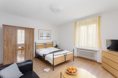 a living room with a bed and a couch at Swiss Star Zurich Sihlfeld - Self Check-In in Zürich