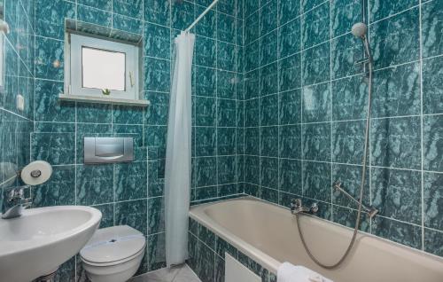 a bathroom with a tub and a toilet and a sink at Maja - Apartment 1 in Funtana