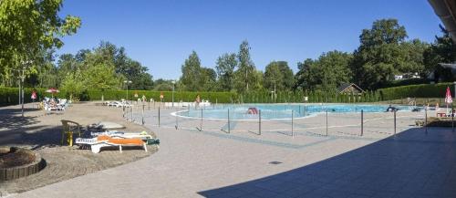 a large swimming pool in a park with at Maison avec véranda proche du centre ville in Rignac - Aveyron