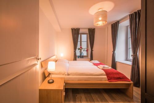 a bedroom with a bed and a table and a window at Dependance Ost in Interlaken