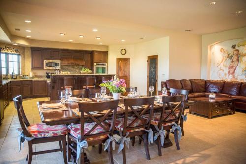 a dining room with a table and a couch at Aterno Estate & Vineyard, Main House & Guest House in Templeton