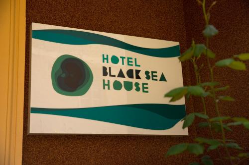 a sign on a wall that reads hotel blackka house at Hotel Black Sea House in Batumi
