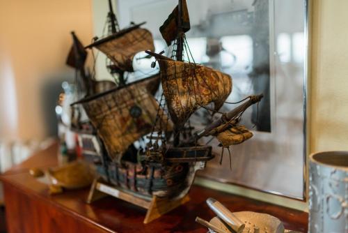 a model of a boat on top of a table at Hotel Duus by Keflavik Airport in Keflavík