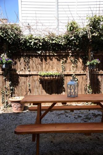 a wooden bench sitting in front of a wooden fence at Nest Hudson in Hudson