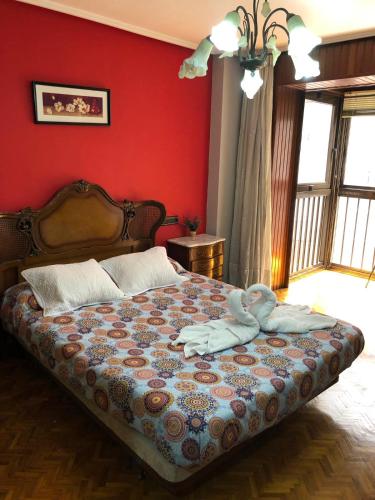a bedroom with a bed with two towels on it at Piso Ourense Bonito y Termal in Ourense