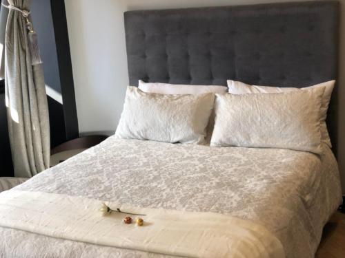 a bedroom with a bed with two cherries on it at Luxury Onyx Penthouse with Sea Mountain Views by CTICC Cape Town in Cape Town