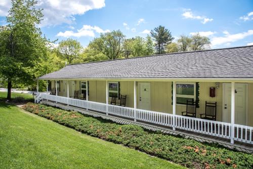 a large yellow building with a white porch at Boxwood Lodge Blowing Rock near Boone-University in Blowing Rock