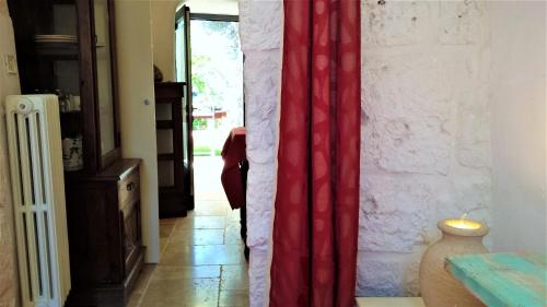 a room with a red curtain and a doorway at Casa Vacanze Riposo Del Vento in Cisternino
