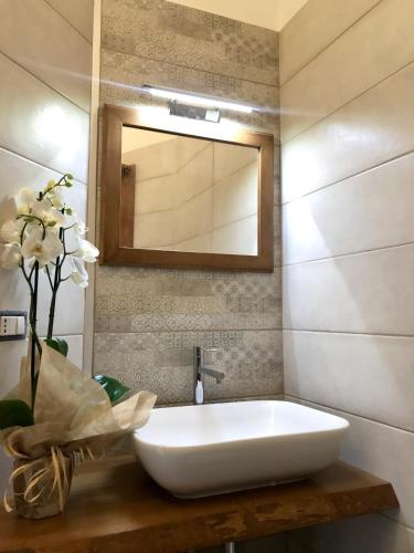 a bathroom with a white sink and a mirror at Paradisea Taormina in Taormina