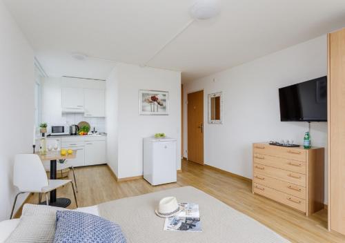 a white apartment with a kitchen and a living room at Swiss Star Tower - Self Check-In in Zürich