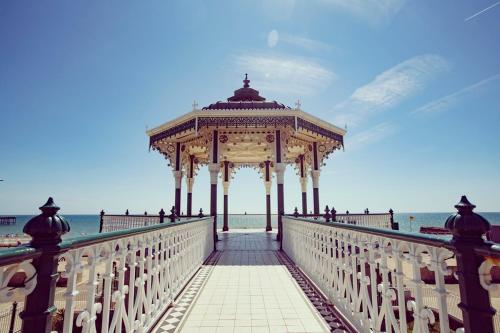 a wooden gazebo on a bridge over the ocean at The Pearl - Stylish 3 Bedrooms house in great central location in Brighton & Hove
