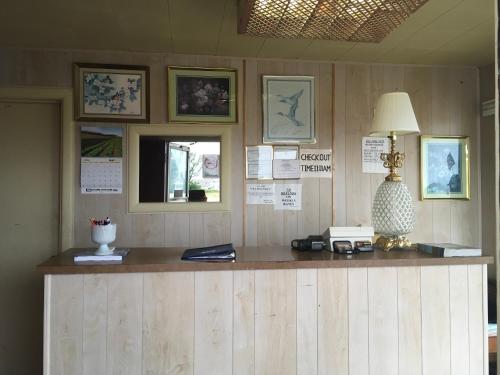 a wooden counter with a lamp on top of it at Hagman Motel in Hugoton