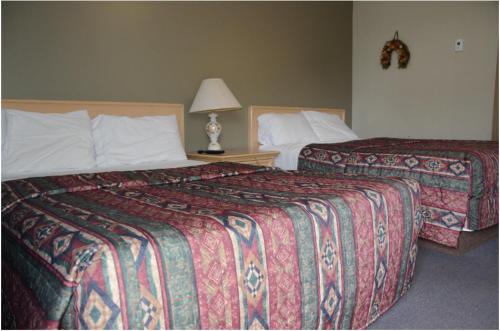 A bed or beds in a room at Trans Canada Motel