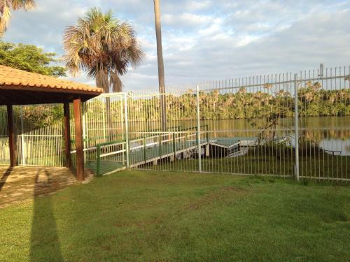 a fence with a pool in a yard at Chalé em Barreirinhas - Porto dos Lençóis in Barreirinhas
