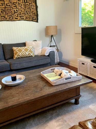 a living room with a couch and a coffee table at Jetty House in Coffs Harbour