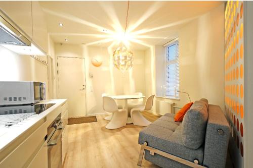 a kitchen with a couch and a table in a room at The best of Copenhagen right at your doorstep no 1 in Copenhagen