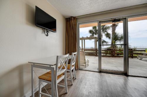 a dining room with a table and a view of the ocean at Seahaven Beach Hotel Panama City Beach in Panama City Beach