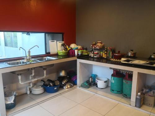 a kitchen with a sink and a counter top at I Love U BnB 爱乐游民宿 步行5 分钟到码头 in Semporna