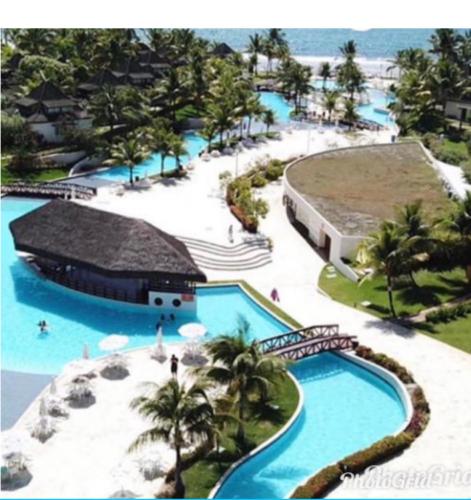 an aerial view of a pool at a resort at Flat Beach Class Resort Muro Alto in Porto De Galinhas