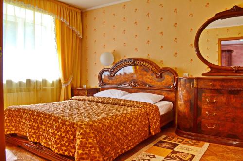 a bedroom with a bed and a large mirror at Hotel Kolos in Barnaul