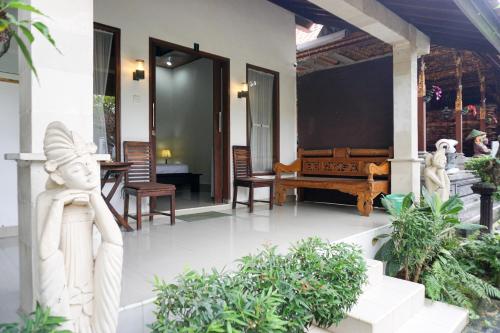 a front porch of a house with a statue at Ary Guest House in Canggu
