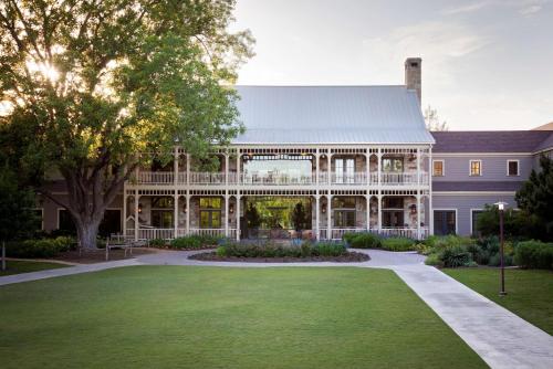 an exterior view of a large house with a lawn at Hyatt Regency Lost Pines Resort and Spa in Cedar Creek